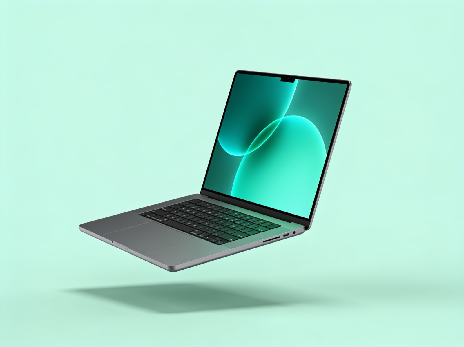 MacBook on mint green background